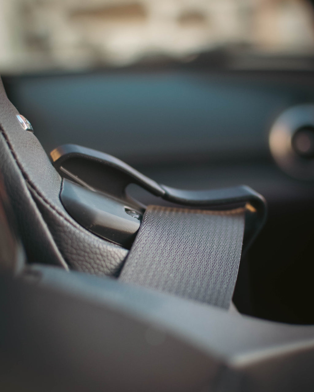 Close-up of a car seat belt inside a vehicle.